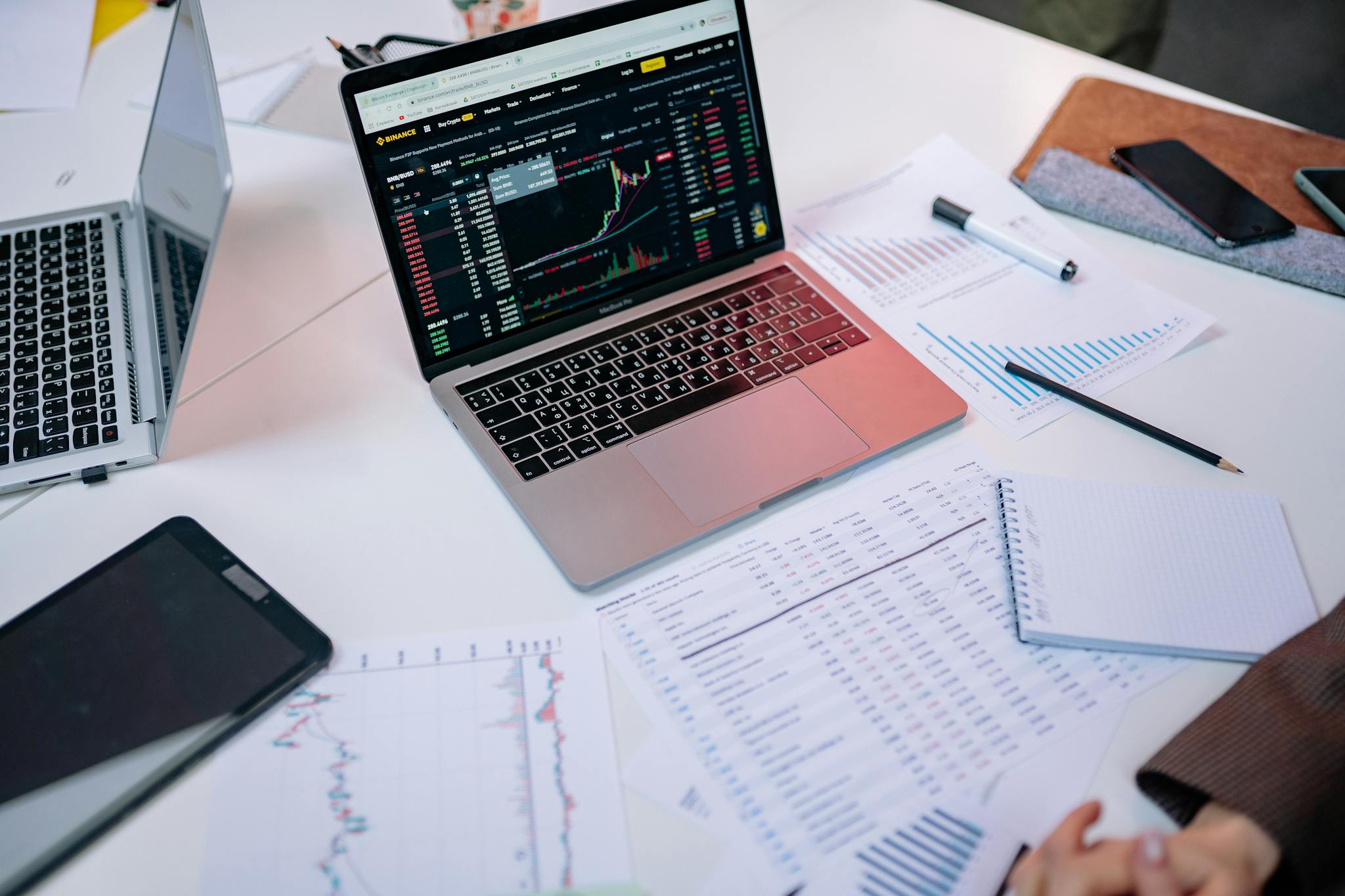 Laptops On A Desk Displaying Stock Market